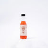 A bottle of Coco Rain, a cold purple tea in Kenya with vibrant purple tea, labeled Baridi Brew.