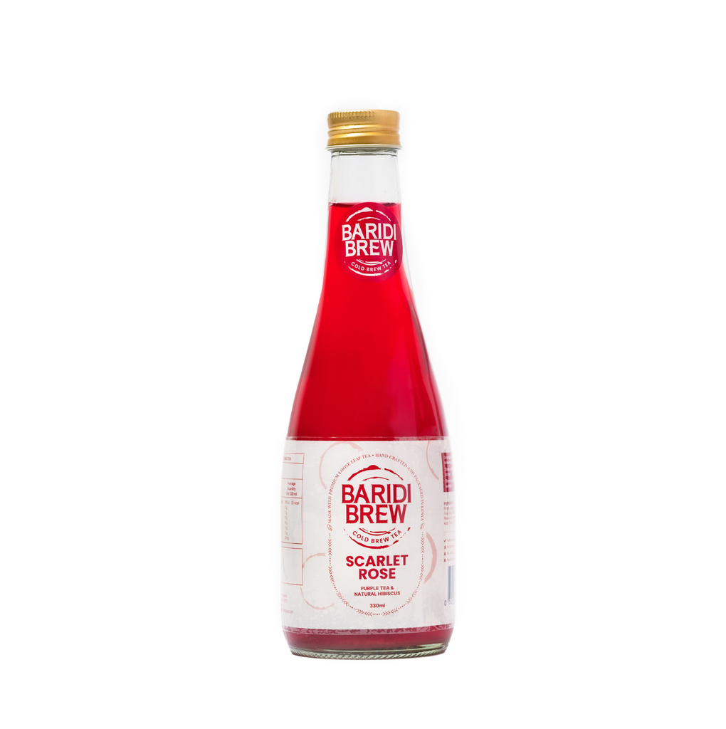 A glass bottle of Baridi Brew Scarlet Rose, a cold brewed tea in Kenya with a red liquid visible and a label on the front.