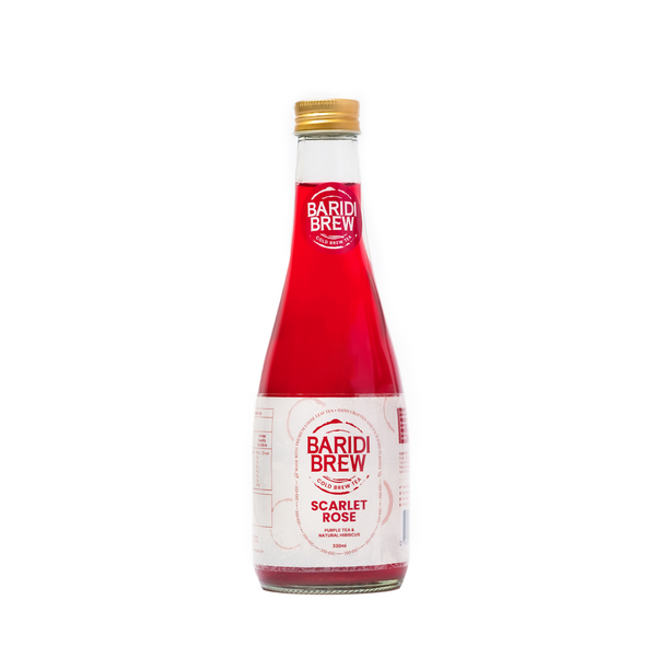 A glass bottle of Baridi Brew Scarlet Rose, a cold brewed tea in Kenya with a red liquid visible and a label on the front.